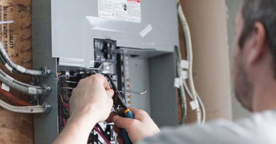 man working on electrical panel